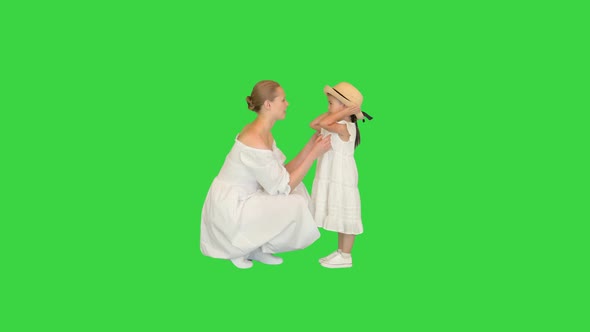 Mother and Daughter Talking with Each Other on a Green Screen Chroma Key