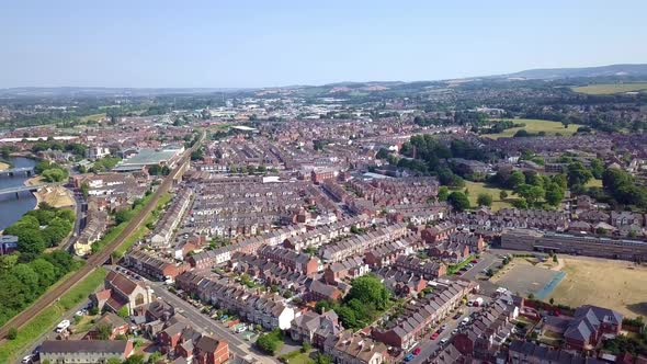 Rows of houses in Exeter, United Kingdom, in Devon, AERIAL PAN losing altitude