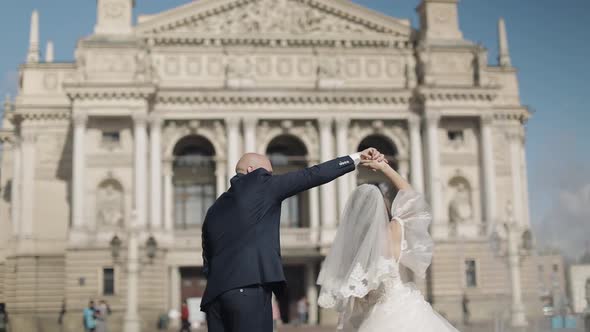 Newlyweds Dance in the Center of the Old Town. Bride and Groom. Wedding