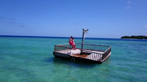 Teenage lovers tan on perfect coast beach adventure by transparent sea with white sand background of