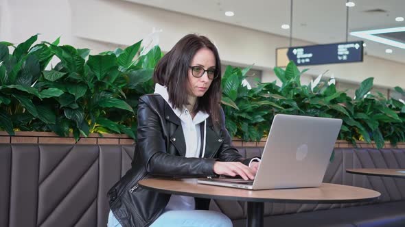 Young Professional Female Manager Using Laptop in Mall Businesswoman Working From Cafe Via Laptop