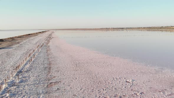 Crystallized salt in upper Kuyalnik estuary, Ukraine. Old wooden structures on Kuyalnik 