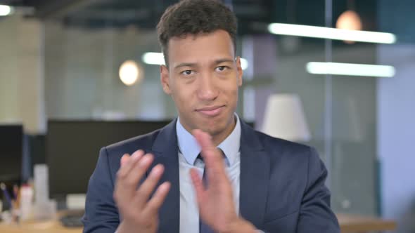 Portrait of Cheerful Young Businessman Clapping