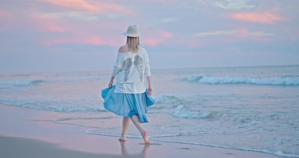 Female Traveler Is Enjoying Sunset and Nature of Ocean Shore, California, USA