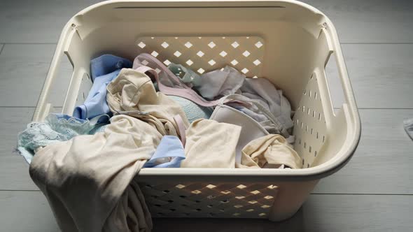 Laundry. Basket for Dirty Laundry, the Preparation for a Big Wash, Top View. White Bed Linen Is