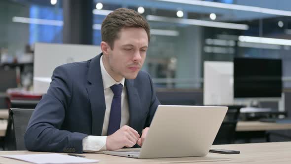 Businessman Working on Laptop in Office