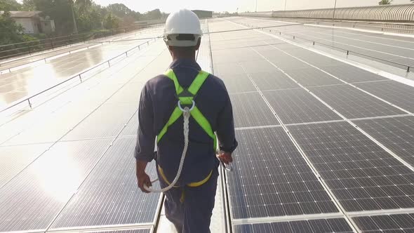 Worker on Solar Panels Sun