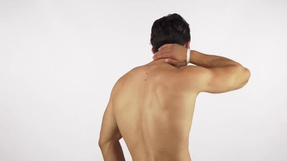 Rearview Shot of a Muscular Male Athlete Suffering From Neck and Back Pain 1080p