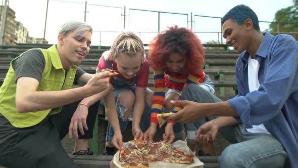 Young Happy People Eating Pizza Outdoors, Friends Relaxing Together Outdoors