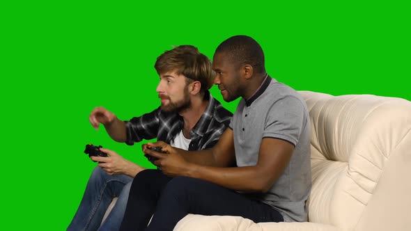 Men Playing Video Games Against Each Other. Green Screen