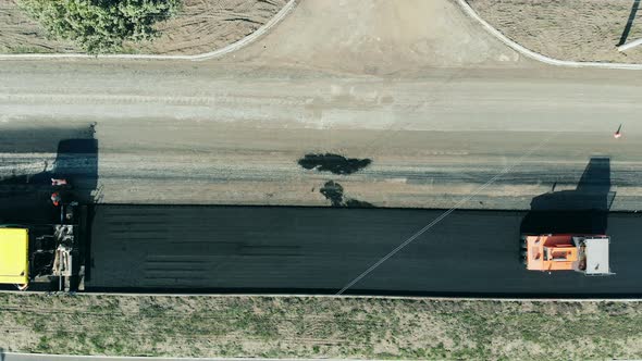 Road Construction Process. Top View of a Roadway in Progress with the Rolling Vehicles