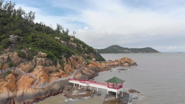 Orbiting aerial view of traditional Chinese pagoda in Coloane, Macau