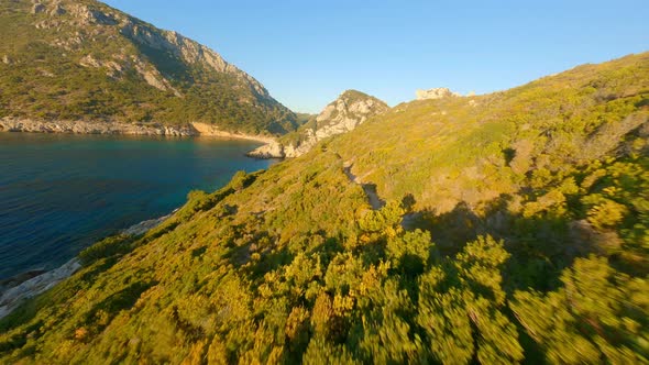 Drone Over Sunlit Corfu Landscape And Coastline