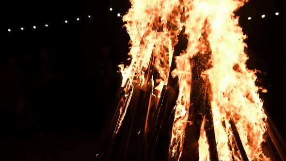 Big Bonfire Burns at Night in Slow Motion on a Black Background on Nature