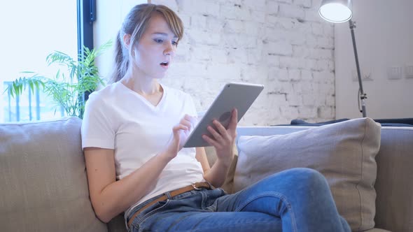 Reaction to Loss by Woman Using Tablet in Bedroom