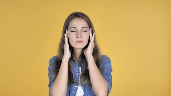 Pretty Woman with Headache Isolated on Yellow Background