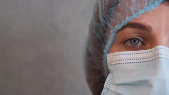 Nurse with Protective Medical Cap and Surgical Face Mask During the Coronavirus