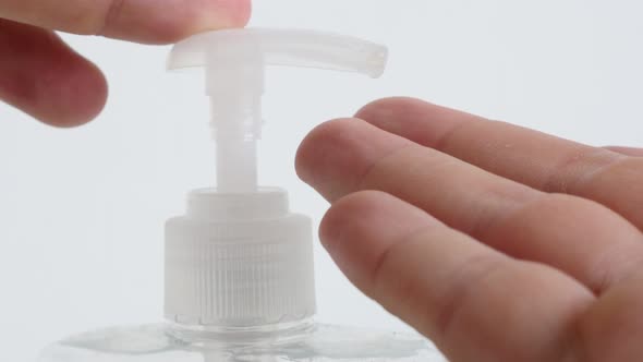 Sanitizer gel pump and hand close-up 4K video