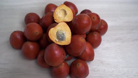 Close up: Pile of Chontaduro fruits with pit inside - Fruit tasted like a raw sweet potato.