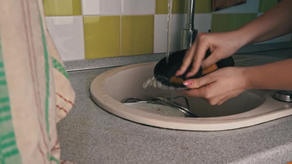 Girl's Hands are Washing Plate with Washcloth and Detergent in Full Sink Slowmo