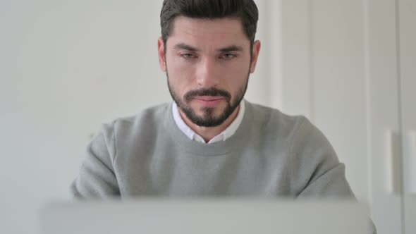 Close Up of Man Coughing While Using Laptop