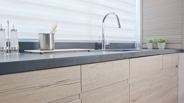 Tracking shot of a luxury kitchen with wood finish modern design