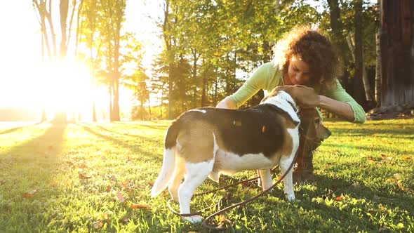 Woman playing with dogs at park, slow motion