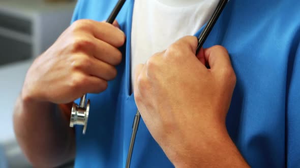 Doctor holding stethoscope in hospital