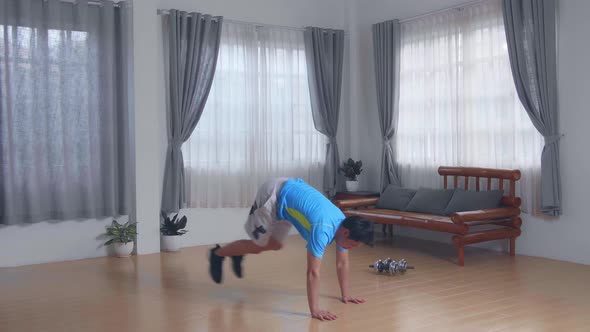 Young Man Doing Jack Burpee Exercises At Home