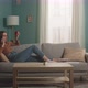 Young Girl with Red Apple Lies on Sofa and Talks on Phone - VideoHive Item for Sale