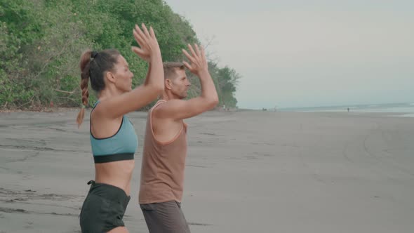 People Practicing Breathing Techniques on Beach