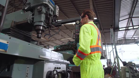 Smart Factory Worker Using Machine in Factory Workshop