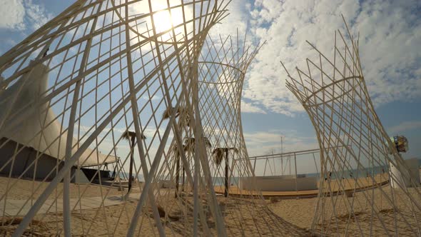 Around the Metal Woven Pavilions Next To the Palm Trees