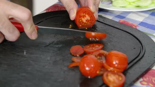 cutting tomatoes on the chopping board