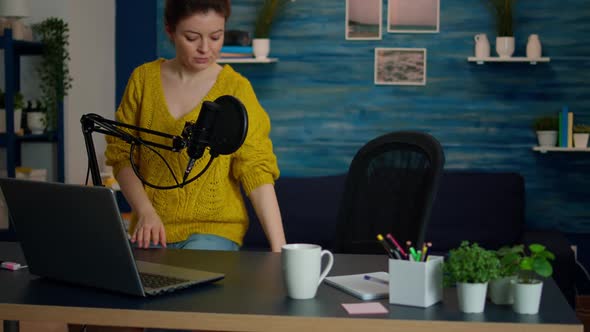 Portrait of Young Vlogger Working in Cozy Studio Smiling at Camera