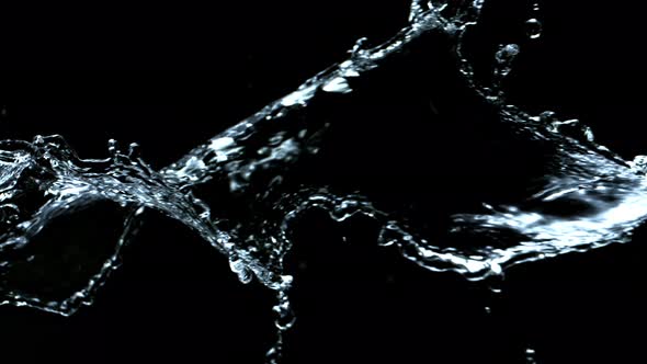 Super Slow Motion Shot of Swirling and Splashing Water Isolated on Black Background at 1000Fps