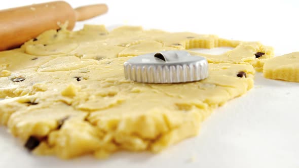 Rolling pin and cookie cutter on dough