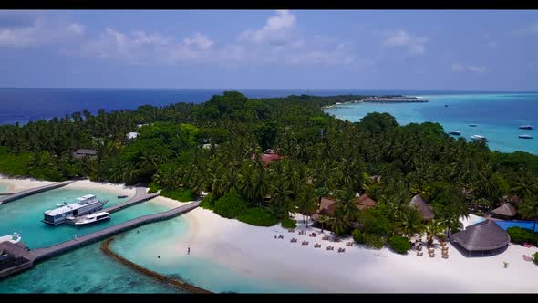 Aerial flying over sky of tranquil seashore beach time by blue sea and white sand background of a da