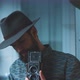 Man wearing hat holds vintage camera towards camera - VideoHive Item for Sale