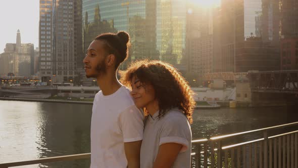 Cute African American couple walk together along the Chicago River