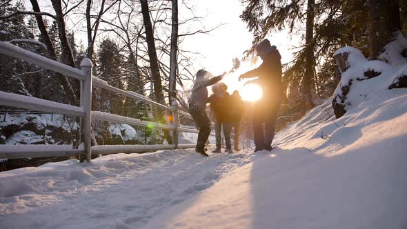 Group of Happy Close Friends Jumps in Winter Forest