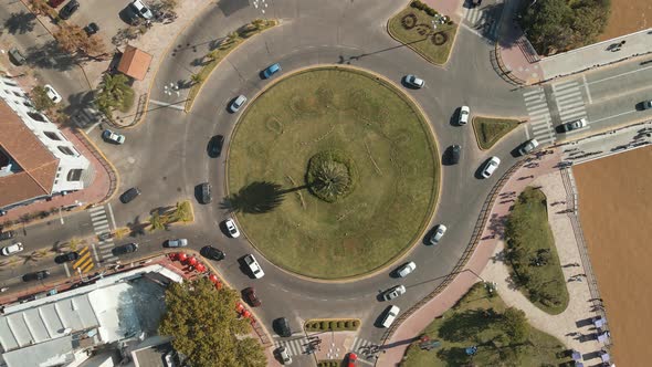 Aerial view of daytime traffic of a roundabout sited in Tigre city, Buenos Aires. Jib up