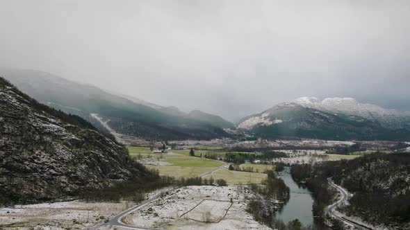 Aerial view of Ardal, Norway. Valley with river and snowy mountain in background