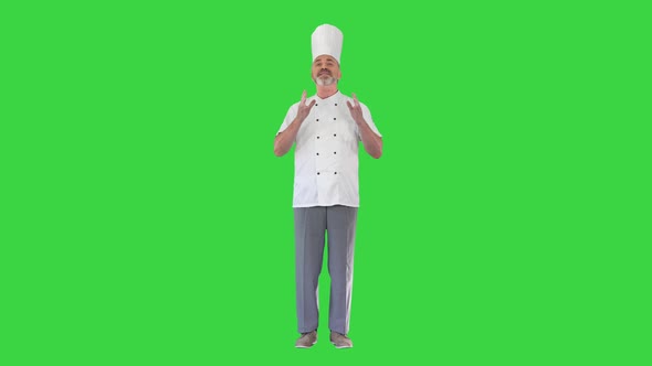 Mature Chef Talking To Camera Explaining Something on a Green Screen Chroma Key