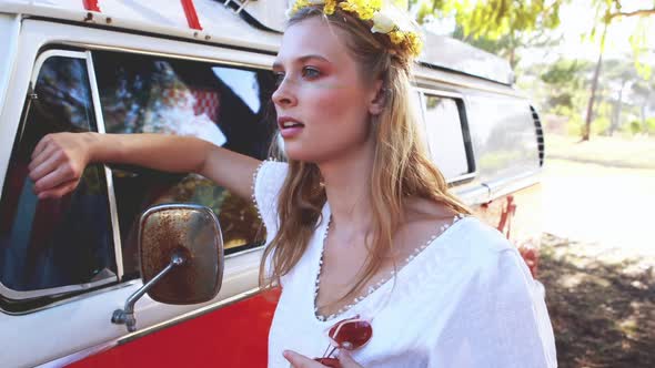 Woman leaning on camper van in the park 4k