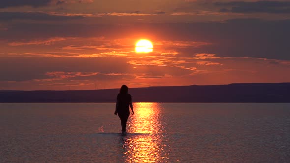 Woman Walking On The Salt Lake During Sunset 4