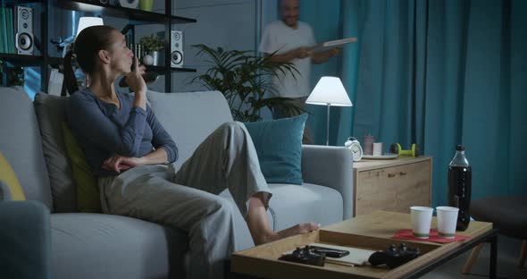 Happy couple receiving pizza at home