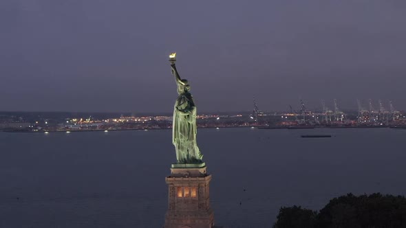 AERIAL: Circling Statue of Liberty Beautifully Illuminated in Early Morning Light New York City