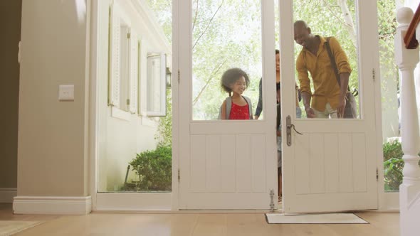 Two generation family entering their house