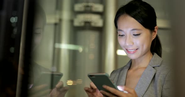 Woman looking at mobile phone in Hong Kong 